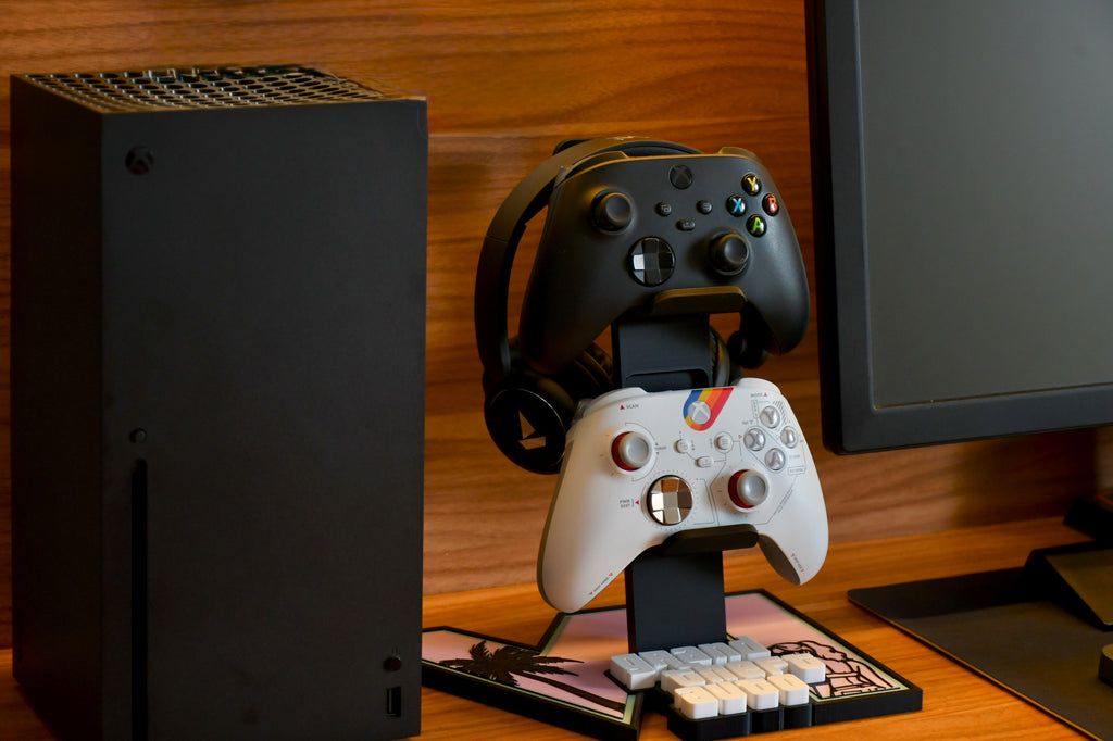 GTA 6 controller and headset stand displayed beside an Xbox console and monitor